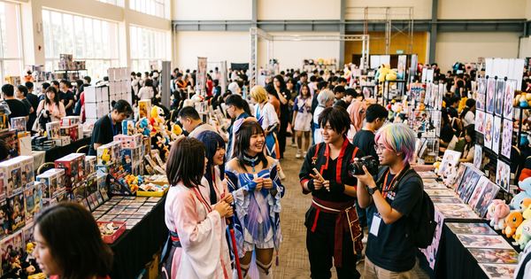 Cosplayers and hobby booths filling an event hall in Kota Kinabalu